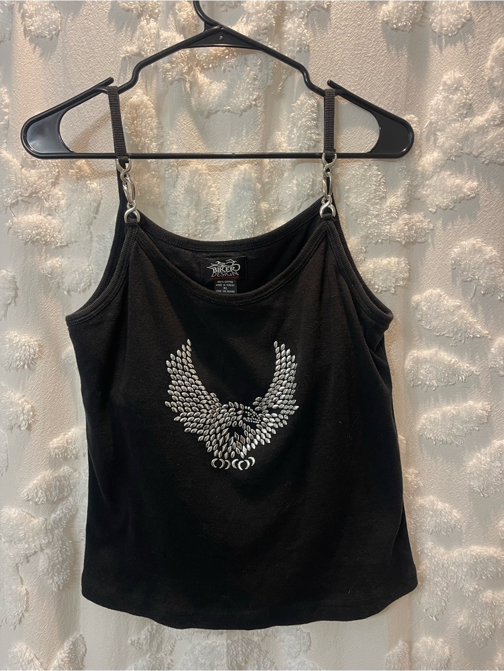 Black tank top with studded silver wings design and silver chain straps